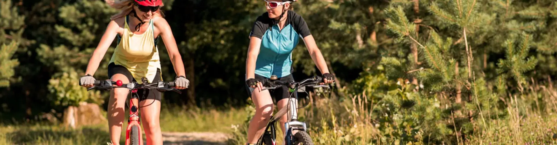 Twee vrouwen fietsen in het park bij goed weer