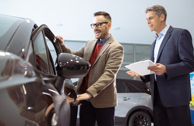 Man is onder de indruk van een auto die hij op het Autosalon ziet.